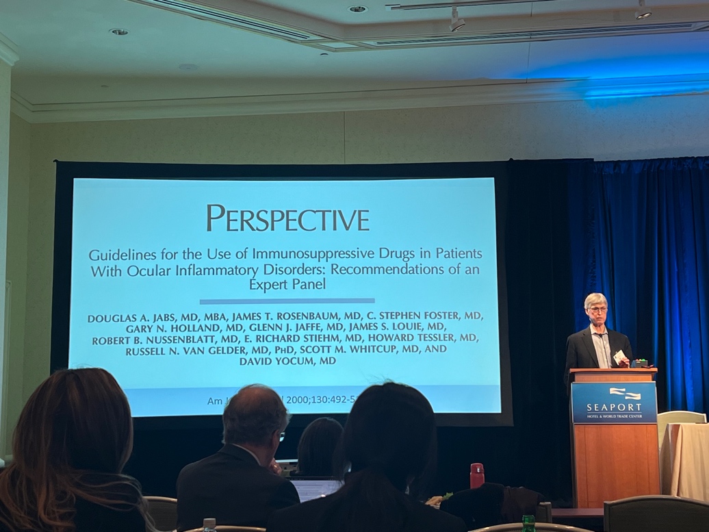 A person giving a presentation Description automatically generated